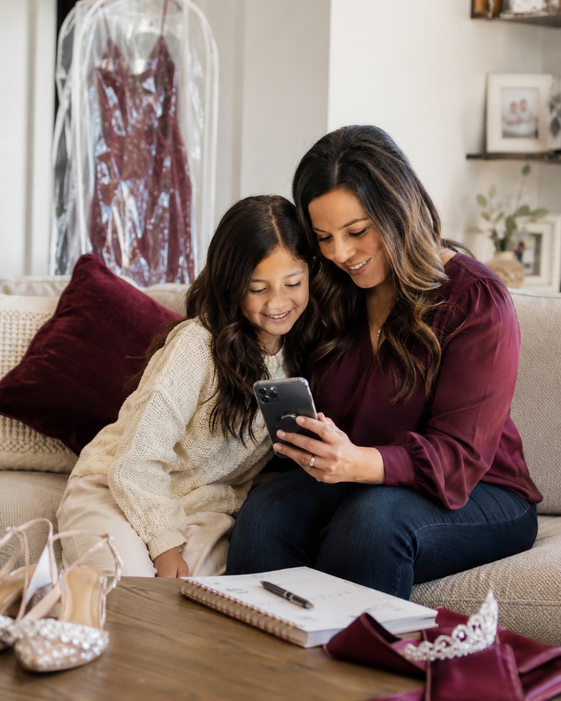 A guardian and young contestant browsing upcoming pageants together on a tablet at home